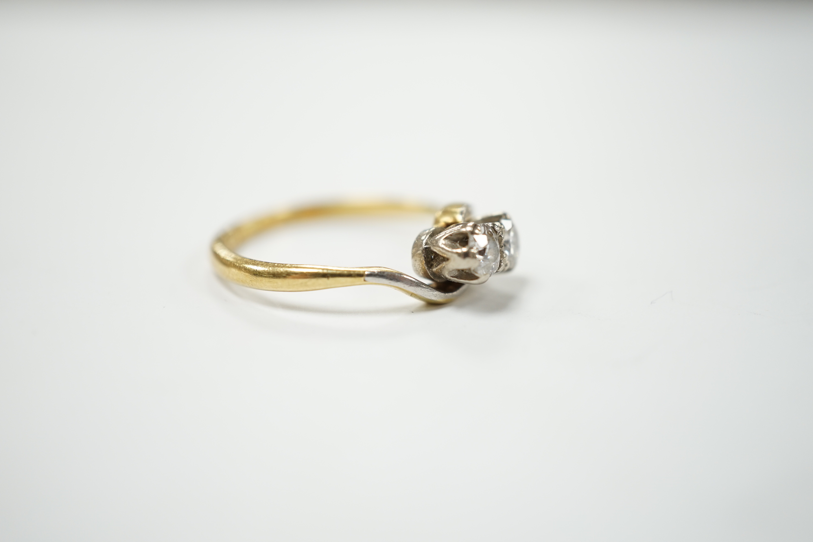 An 18ct gold and platinum two stone diamond ring, size M